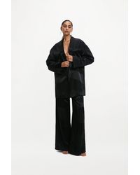 delos.land - Clement Trousers Monogram - Lyst
