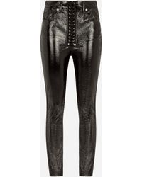 Dolce & Gabbana Jeans aus beschichteter Baumwolle mit Bändern und Lochnieten - Schwarz