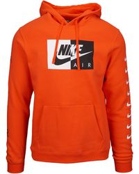black nike hoodie with orange logo