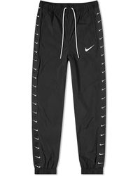 nike swoosh tape tracksuit
