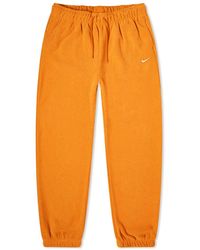 Orange Nike Track pants and sweatpants for Women | Lyst