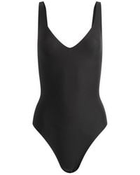 Skims - Body Unlined Plunge Thong Bodysuit - Lyst