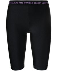 Culottes de ciclismo con logo en la cintura Versace Jeans Couture de Denim de color Negro Mujer Ropa de Shorts de Shorts largos y por la rodilla 