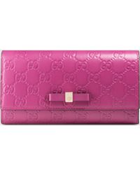 Prada Bow Leather Continental Wallet in Pink (cammeo-blush) | Lyst  