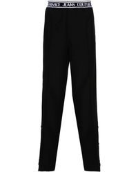 Versace - Pantalones rectos con logo en la cinturilla - Lyst