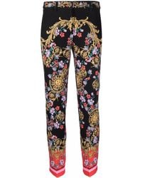 Versace - Pantalones ajustados con motivo barroco - Lyst