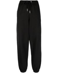Moncler - Pantalones de chándal con parche del logo - Lyst