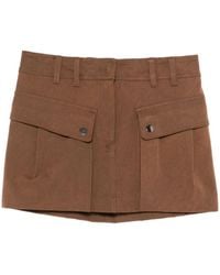 ANDAMANE - Falda corta con detalle de bolsillos - Lyst
