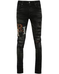 Amiri - Logo-Patch Distressed Skinny Jeans - Lyst