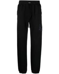 Amiri - Staggered Logo-embroidered Track Pants - Lyst