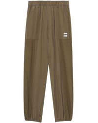 Izzue - Logo-appliqué Tapered Track Pants - Lyst