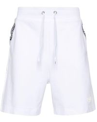 Moschino - Shorts mit Logo-Streifen - Lyst