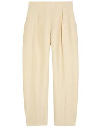 KHAITE - Somera Pleated Pressed-Crease Trousers - Lyst