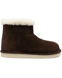 Miu Miu - Shearling-Trim Logo-Embossed Boots - Lyst