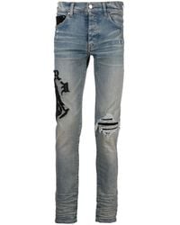 Amiri - Logo-Embroidered Skinny Jeans - Lyst