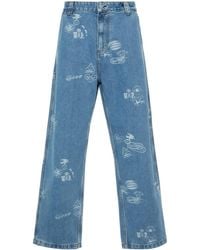 Carhartt - Stamp Graphic-print Tapered Jeans - Lyst