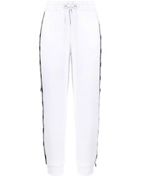 EA7 - Pantalones de chándal con franjas del logo - Lyst