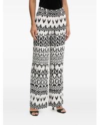 MARCIANO BY GUESS - Logo-Pattern Trousers - Lyst