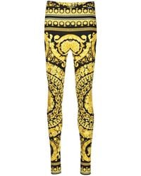 Versace - Leggings in tessuto stretch oro e nero con stampa baroque heriatge allover - Lyst