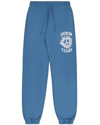 DENIM TEARS - University Logo-Print Track Pants - Lyst