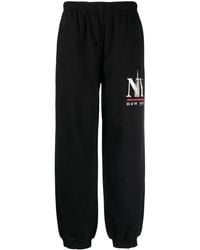 Alexander Wang - Logo-Print Cotton-Blend Track Pants - Lyst