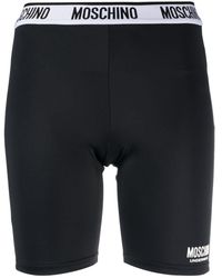Moschino - Shorts mit Logo-Streifen - Lyst