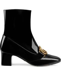embroidered leather ankle boot with belt gucci