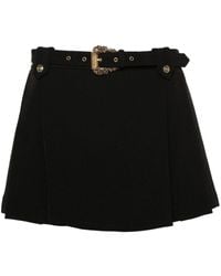 Versace - Logo-engraved Pleated Mini Skirt - Lyst
