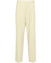 AURALEE - Pleated Wool Tapered Trousers - Lyst