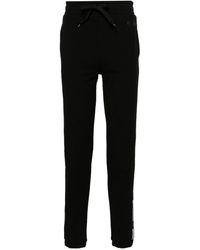 Moschino - Pantalones de chándal con franja del logo - Lyst