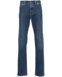 Brioni - Tief sitzende Jeans mit Logo-Schild - Lyst