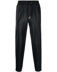 Saint Laurent - Pantalones ajustados con rayas laterales - Lyst