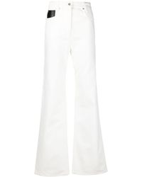 Femme Vêtements Jeans Jeans à pattes d’éléphant 70 % de réduction Jean ample à empiècement logo Jean Paco Rabanne en coloris Blanc 