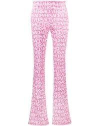 Versace - Logo-Print Flared Trousers - Lyst