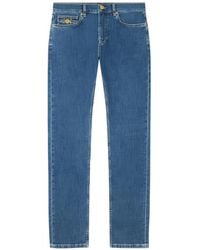 Versace - Denim Jeans Met Medaillon Zak - Lyst