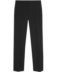 Versace - Pantalones ajustados con aplique del logo - Lyst
