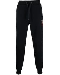 Tommy Hilfiger - Pantalones joggers con logo bordado - Lyst