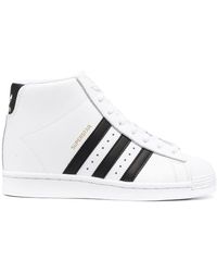 black and white adidas superstar high top