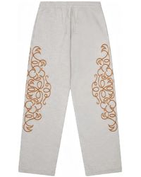 DENIM TEARS - Embroidered Track Pants - Lyst