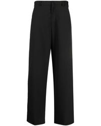 Prada - Pantalones anchos con parche del logo - Lyst