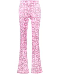Versace - Logo-print Flared Trousers - Lyst