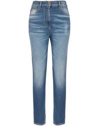 Balmain - Jeans slim con placca logo - Lyst