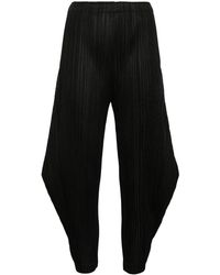 Pleats Please Issey Miyake - Tapered pleated trousers - Lyst