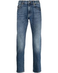 Versace - Jeans slim con applicazione - Lyst