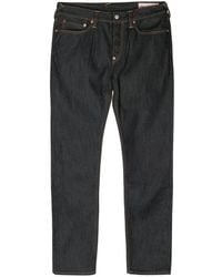 Evisu - Schmale Jeans mit Logo-Patches - Lyst
