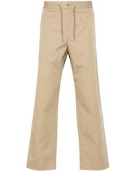 Moncler - Pantalones ajustados con aplique del logo - Lyst
