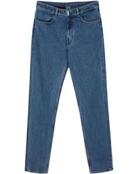 Givenchy - Slim-Fit-Jeans mit Logo-Schild - Lyst