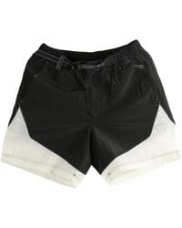 and wander - X Roa Panelled Belted Shorts - Lyst