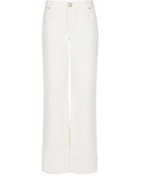 Balmain - Logo-Patch Denim Jeans - Lyst
