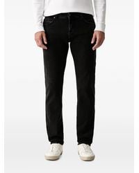 ARMANI EXCHANGE - Logo-Patch Jeans - Lyst